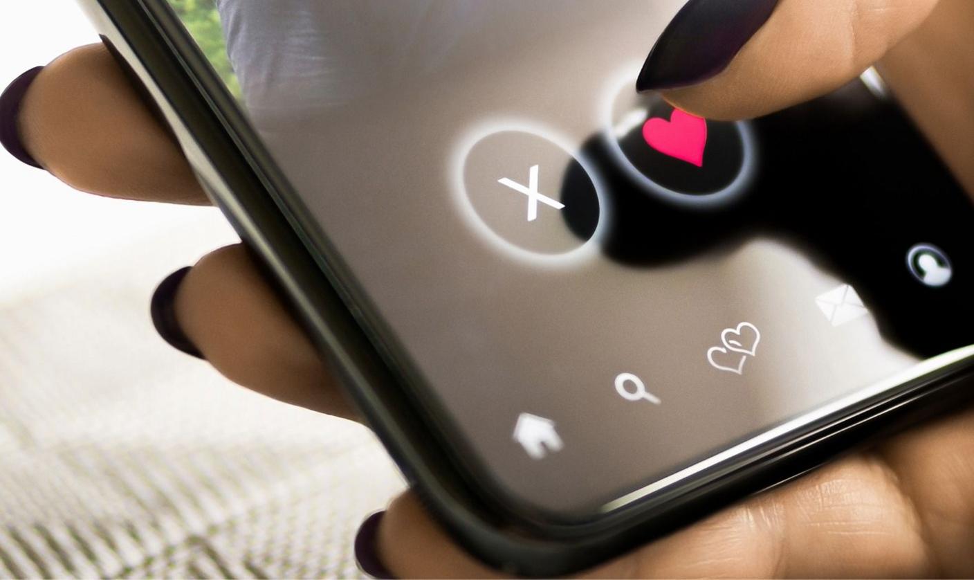 Woman pressing heart on mobile phone