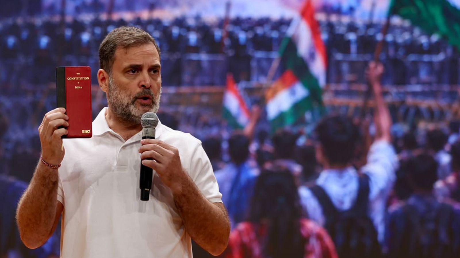 Rahul Gandhi holds a copy of the Indian Constitution during a press conference