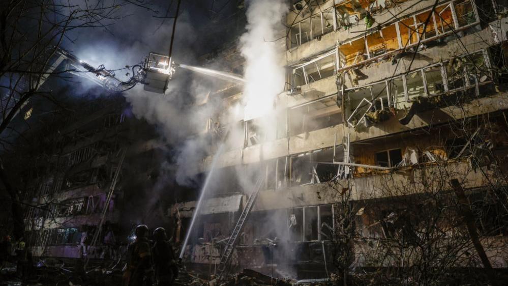 Ukrainian rescuers search a strike site in Kyiv