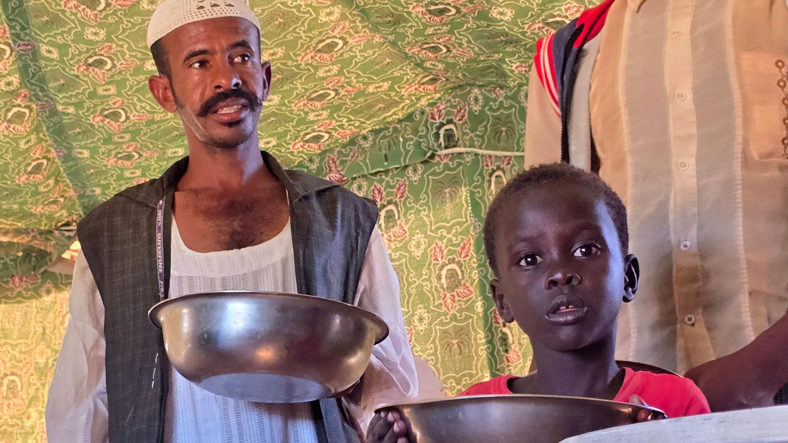 Man holding a bowl in Sudan