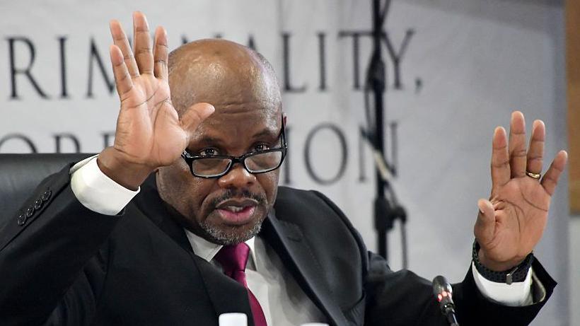 Lt Gen Sibiya with hands up