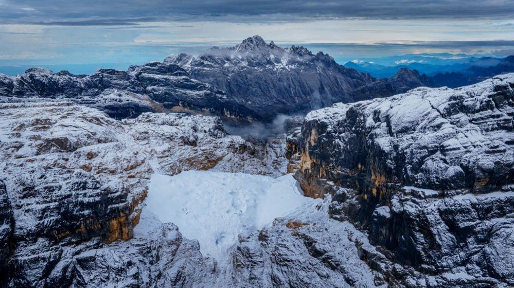 Aerial view of the Sudirman Range, with small snow patch