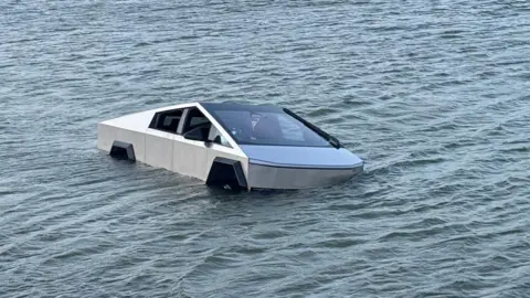Tesla Cybertruck Adventure Takes a Dangerous Turn: Driver Arrested After Lake Incident!