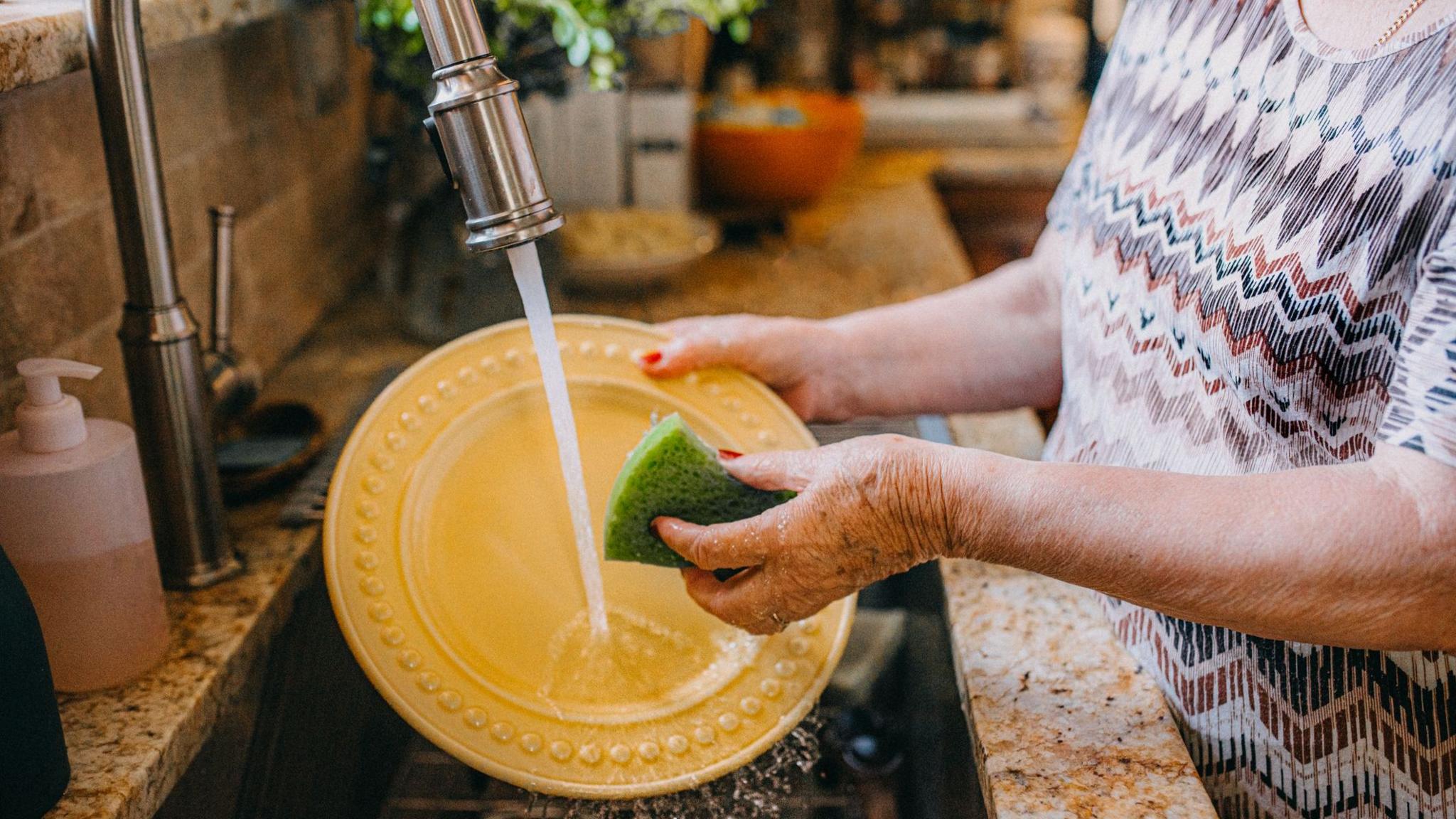 Woman washing dishes in a kitchen