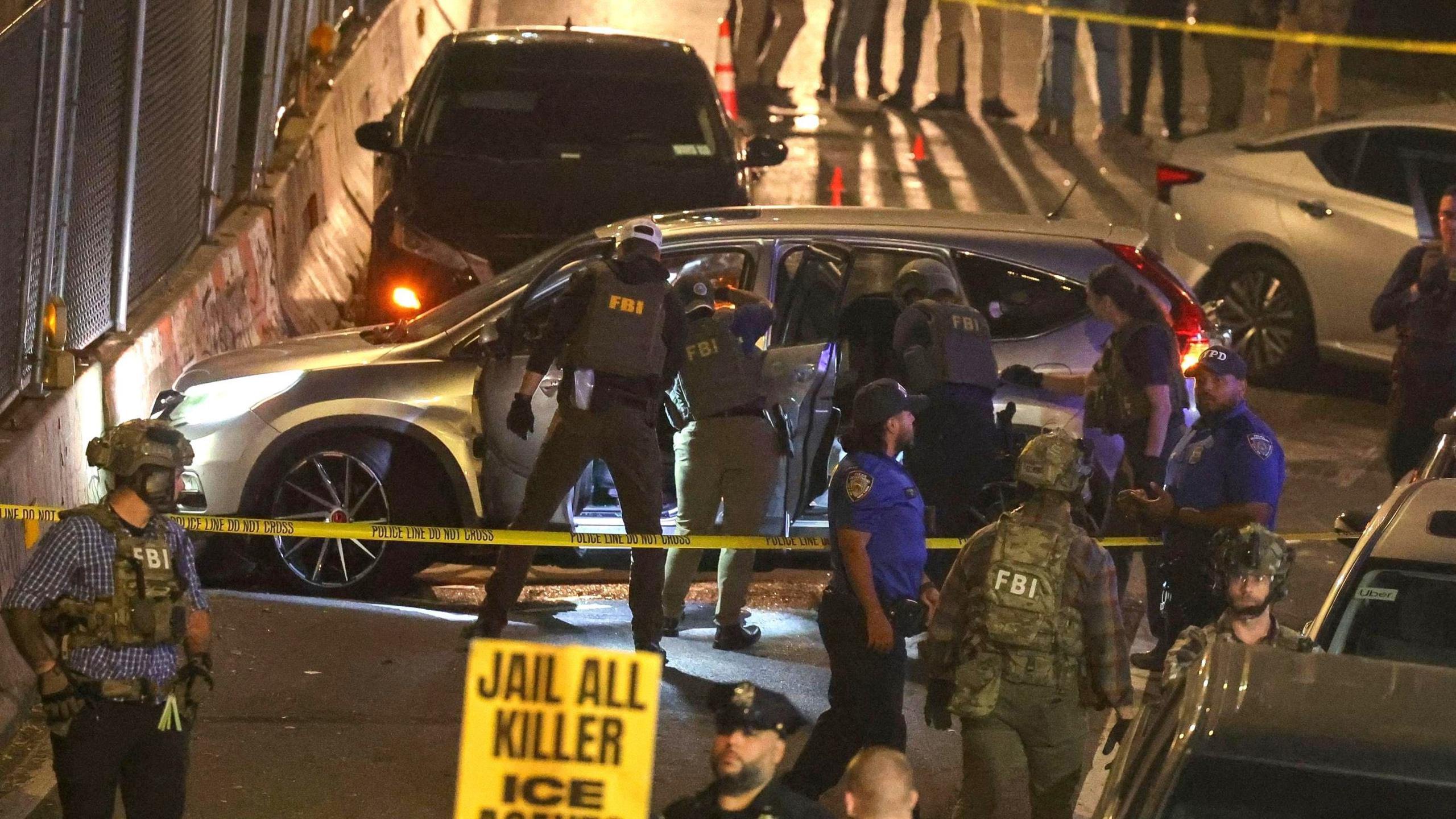 FBI officers searching a car at the scene on Thursday night