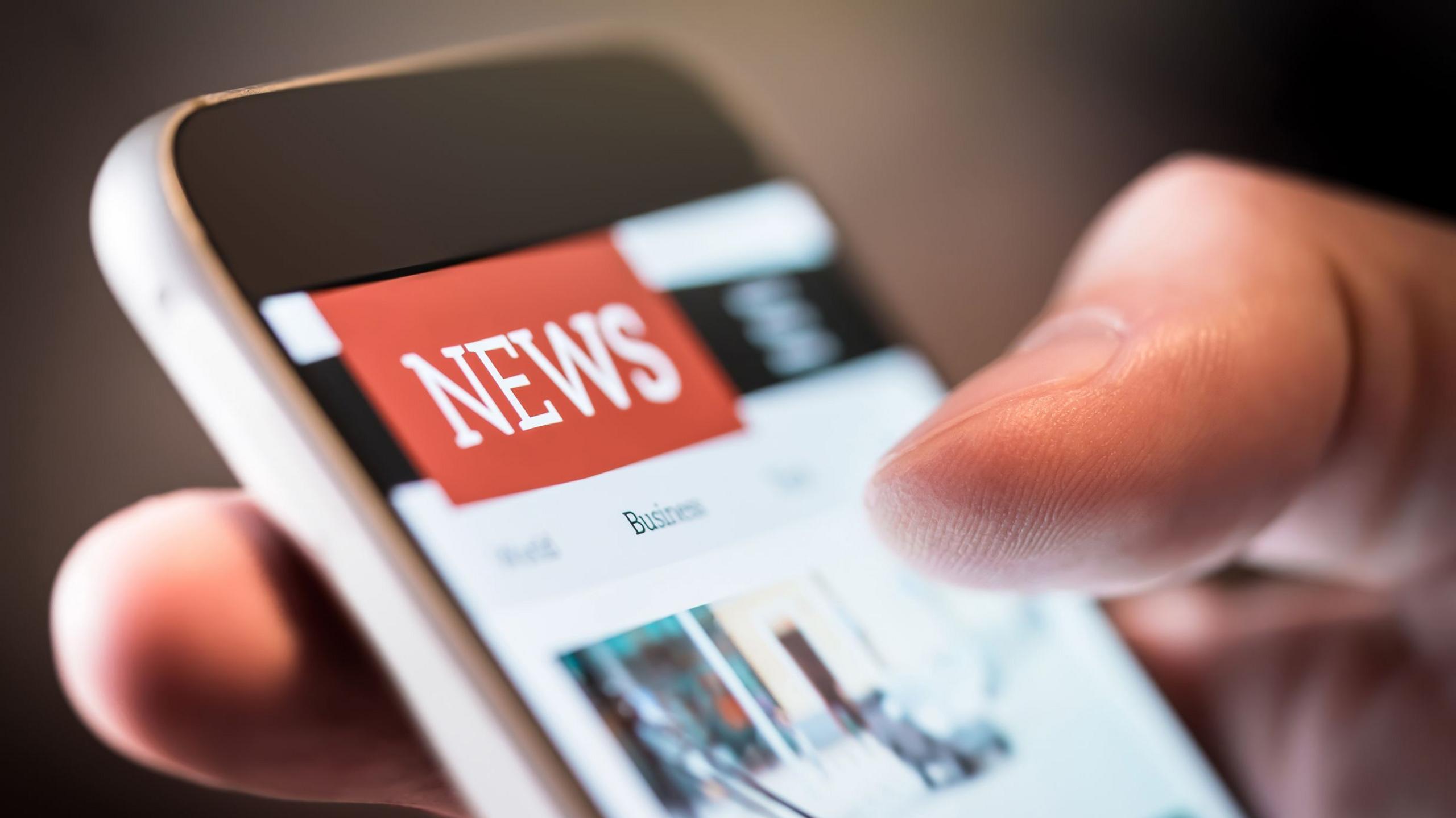 Phone screen showing news logo